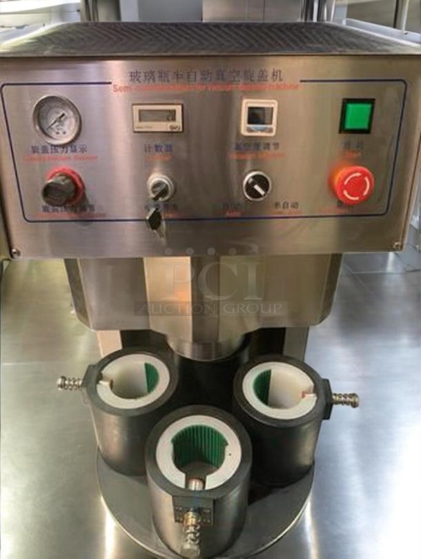 Tang Machinery four-station vacuum capper, superb condition, fully tested. Control panel with gauges and switches visible.