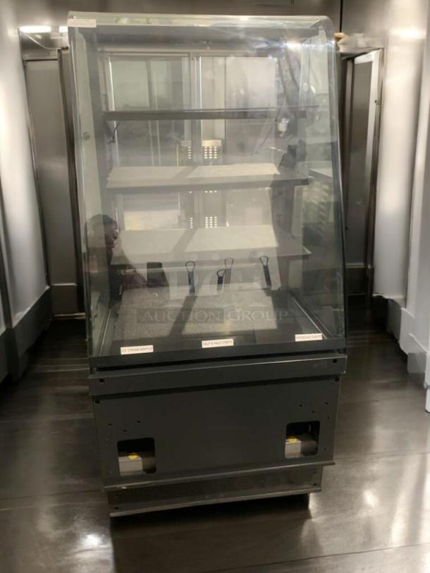 Refrigerated bakery/deli display case, superb condition, full glass front, multi-shelf, tested & working, visible labels.