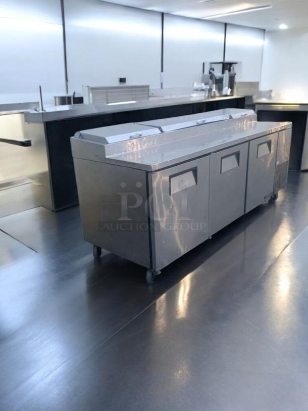 True TPP-93 refrigerated pizza prep table, 93", stainless steel, prime condition, fully tested, 115V, on wheels.