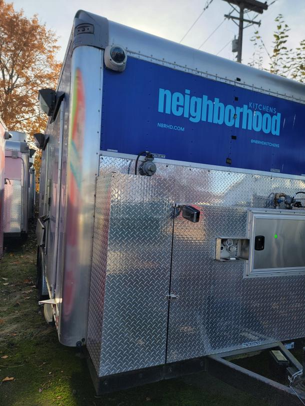 2021 Quality 16' mobile ghost kitchen trailer with stainless steel interior, large service window, and "neighborhood" branding.