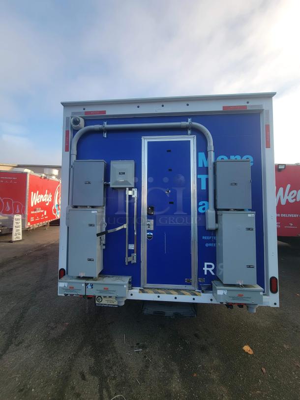 2021 Quality 16' mobile commercial food trailer, rear view showing access door, electrical boxes, and blue exterior.