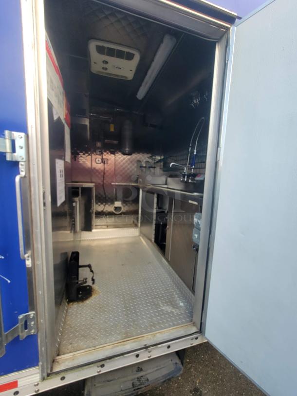 2021 16' Quality mobile commercial kitchen trailer interior with stainless steel fittings and 200 AMP electrical service.