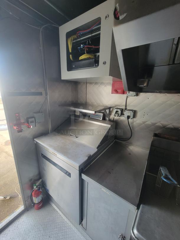 2021 Quality 16' mobile commercial food trailer interior; stainless steel, with Arctic Air units, fire extinguisher, POS area.