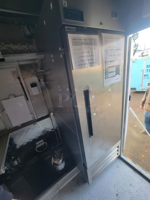 2021 16' mobile commercial ghost kitchen trailer interior with Arctic Air AF23Z freezer, stainless steel finish, and safety equipment.