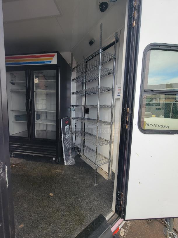 Interior of 2021 SDG trailer showing chrome wire shelving, True Refrigeration unit, and secure flooring.