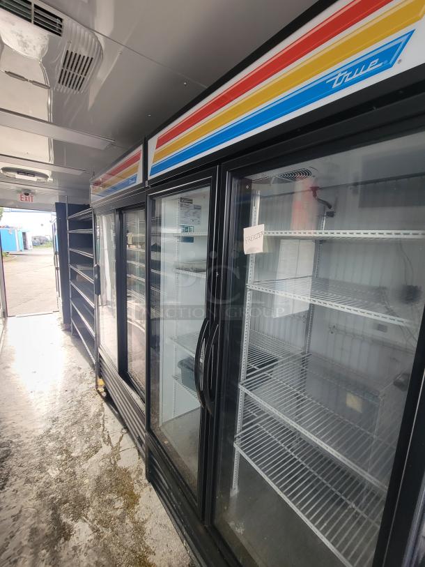 Interior view of SDG 2021 food trailer showing True Refrigeration units, chrome wire shelving, and stainless steel countertop.