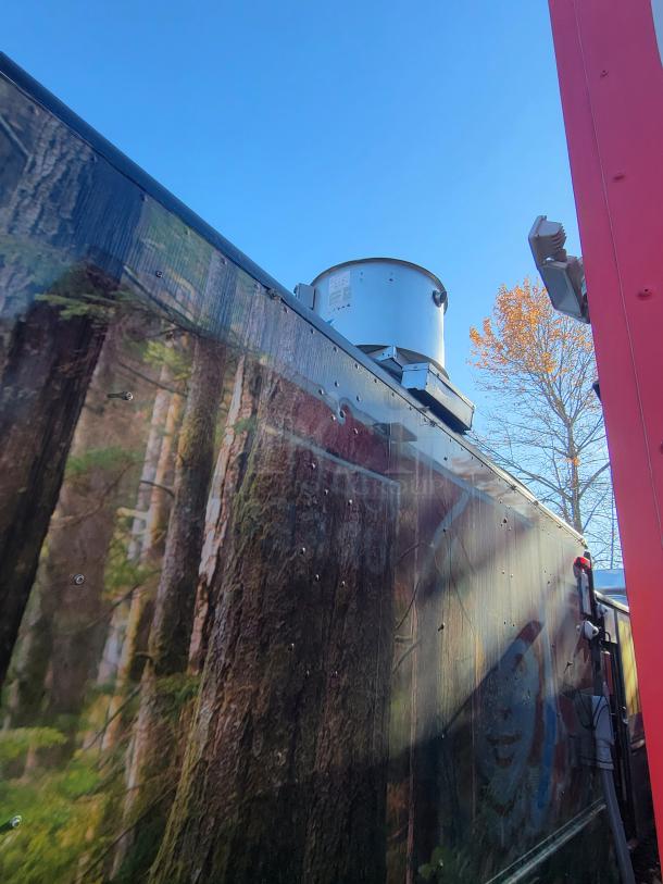 2004 Freightliner MT45 step-van with external kitchen exhaust. Forest-themed exterior wrap visible.