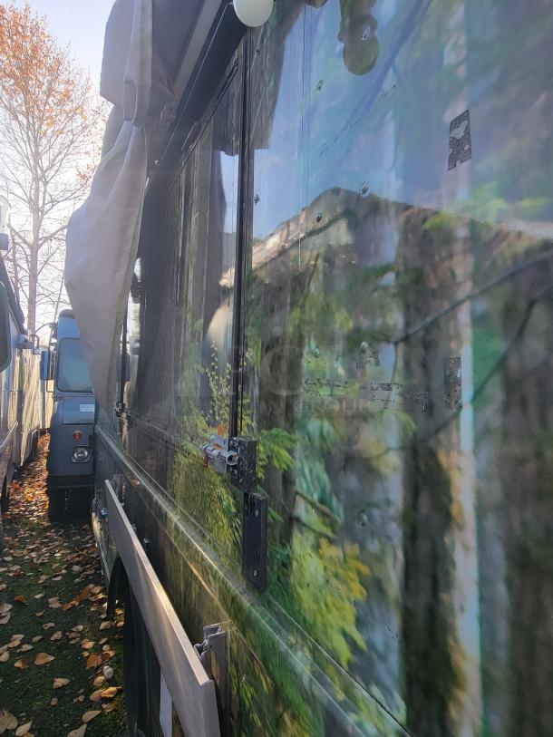 2004 Freightliner MT45 Step-Van mobile kitchen with exterior forest graphics, featuring stainless steel hardware.