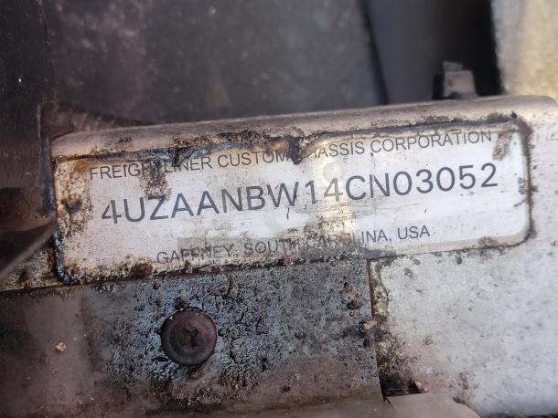 VIN tag on a 2004 Freightliner MT45 chassis; visible markings include VIN: 4UZAANBW14CN03052, Gaffney, SC, USA.