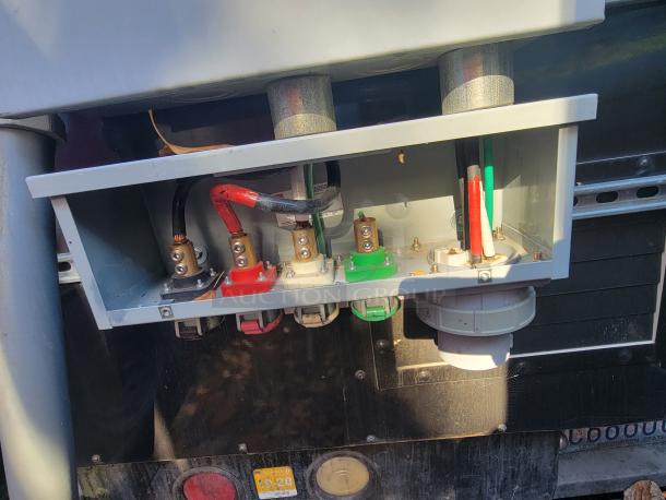 Electrical connection panel on 2004 Freightliner MT45 mobile kitchen, featuring multi-colored wiring and external shore power plug.