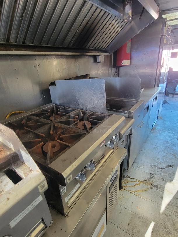 2004 Freightliner MT45 mobile kitchen with stainless steel interior, Southbend griddle, Dean fryer, exhaust hood, fridge/freezer.