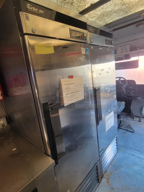 Turbo Air Upright Refrigerator/Freezer in a 2004 Freightliner MT45 mobile kitchen, featuring stainless steel panels and visible control panel.