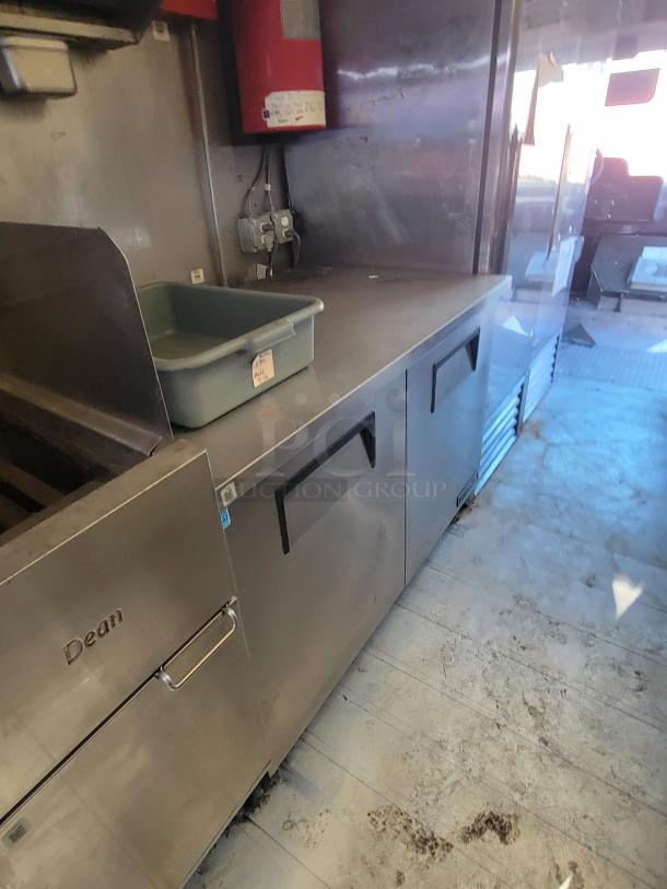 2004 Freightliner MT45 mobile kitchen with Dean gas deep fryer, stainless steel interior, and integrated fire suppression.