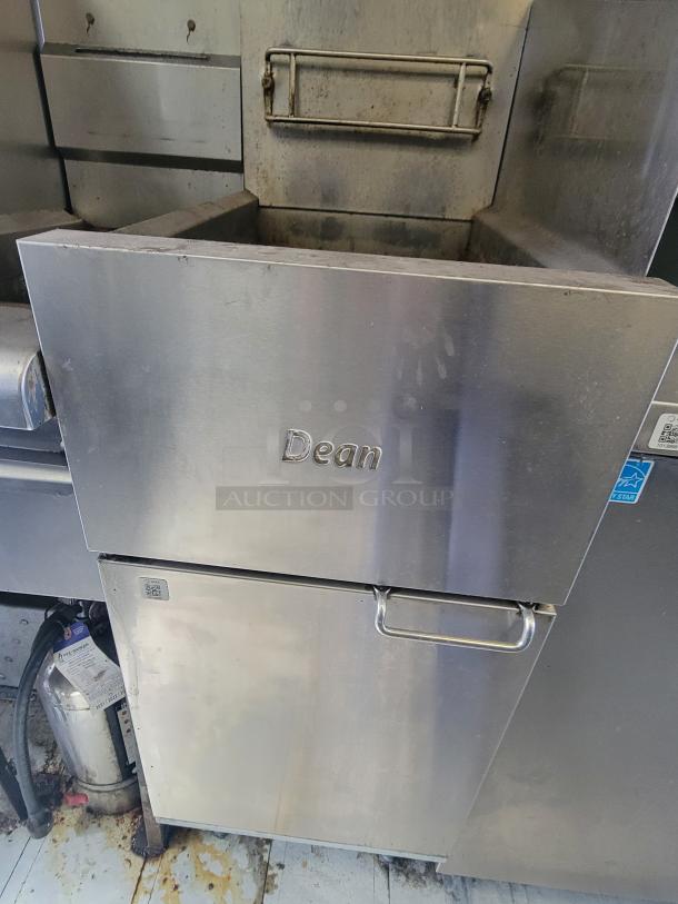Stainless steel Dean gas deep fryer in a commercial mobile kitchen, featuring sturdy construction and a fire extinguisher nearby.