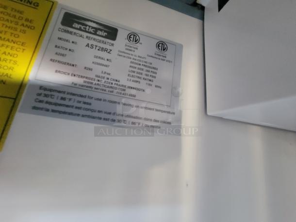 Arctic Air commercial refrigerator label inside a mobile kitchen trailer. Model: AST28RZ, uses R290 refrigerant.