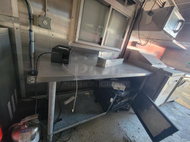 Interior of a 2020 24' Diamond Cargo mobile kitchen trailer with stainless steel counters, electrical outlets, and commercial-grade equipment including refrigeration units. Ideal for catering and delivery operations.