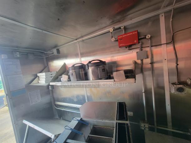 Interior of a 2020 24' Diamond Cargo mobile kitchen trailer. Features visible wiring, shelving, and appliances.