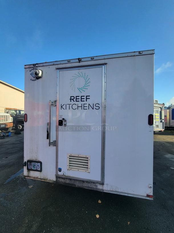White 2020 24' Diamond Cargo mobile kitchen trailer with "Reef Kitchens" branding, showing back entrance and Oregon license plate U595252.