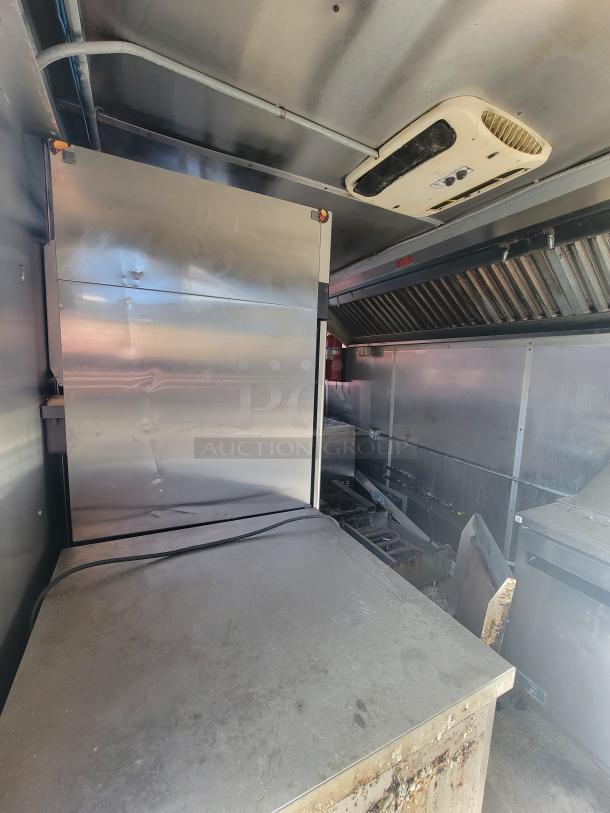 Fully-equipped 2020 24' Diamond Cargo mobile kitchen trailer interior. Features stainless steel surfaces, commercial cooking line, and refrigeration units.