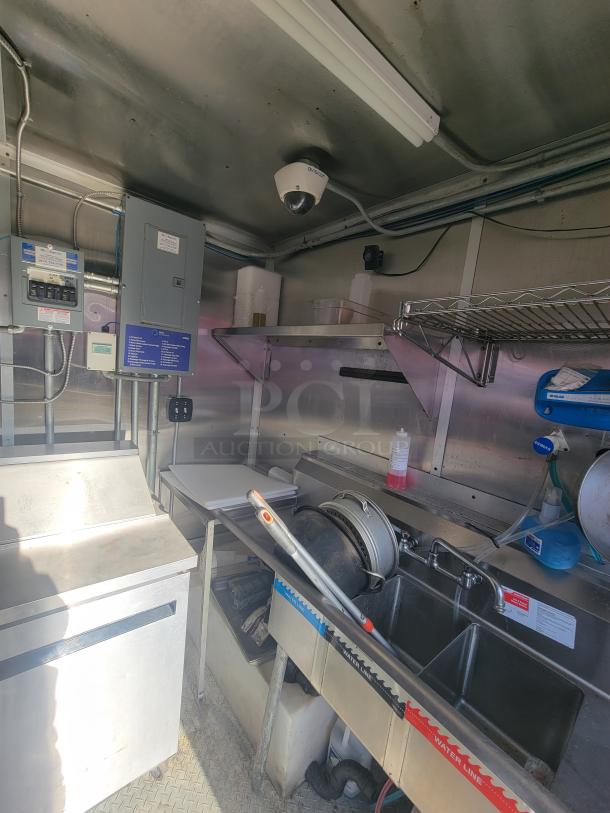 2020 24' Diamond Cargo mobile ghost kitchen trailer interior. Features commercial-grade equipment, 3-compartment sink, and electrical panel.