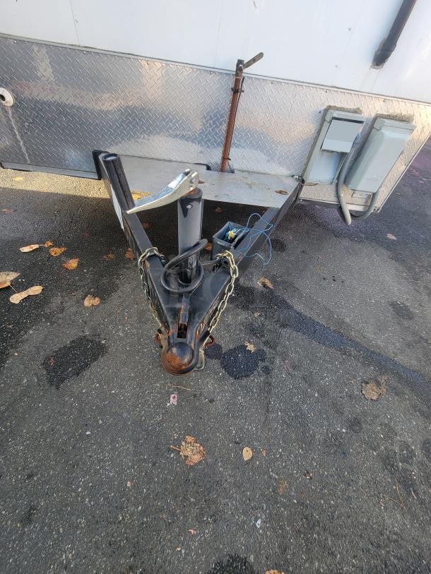 Diamond Cargo 24' mobile kitchen trailer hitch, with electrical connections and safety chains visible.