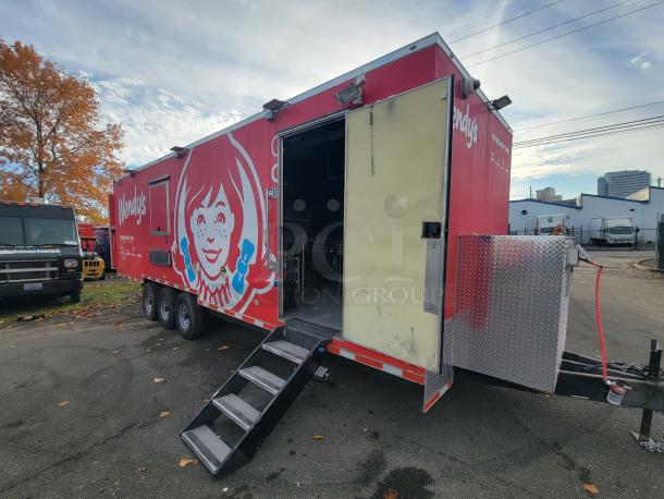 2022 28' Titanium Cargo Food Trailer with Wendy's branding, triple axle, stairs, and side entrance, ready for business.