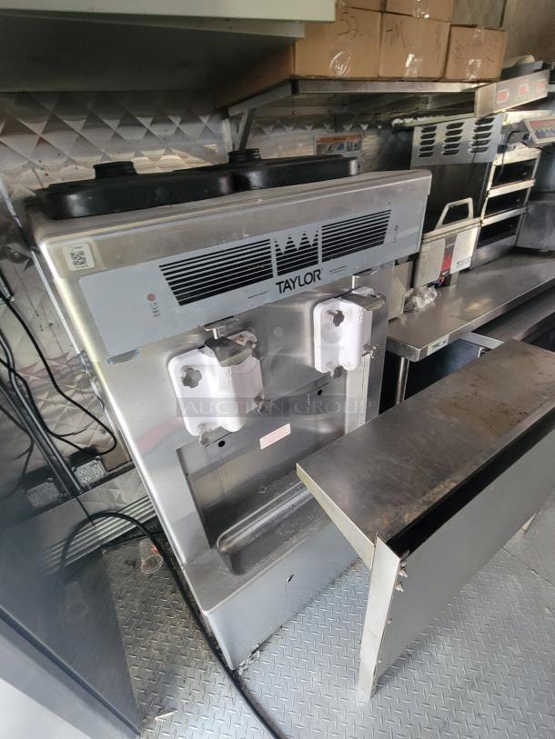 Taylor Soft Serve Machine inside a 2022 Titanium 28' Food Trailer. Features dual dispensers, commercial-grade, good condition.