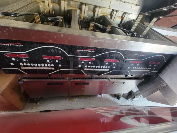 2022 28' Titanium Cargo food trailer interior showing Henny Penny Gas Pressure Fryer; surface wear visible on controls.