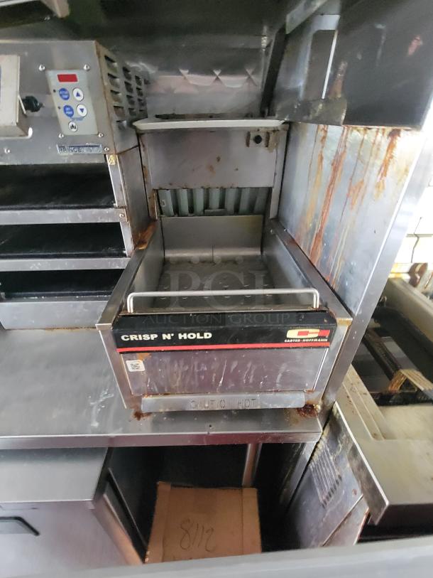 Carter-Hoffmann Crisp 'N Hold food warmer inside a 2022 Titanium Cargo 28' food trailer, showing signs of wear.