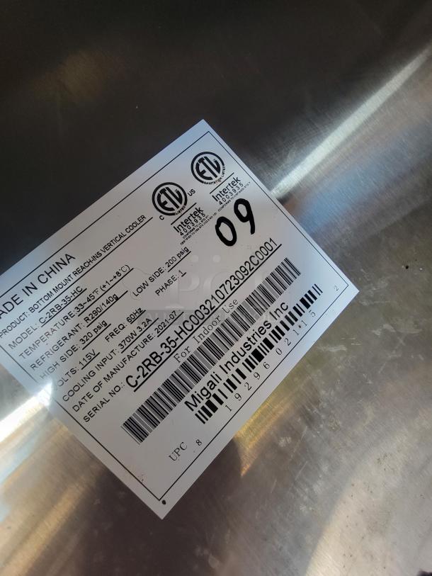 Migali Industries Inc label on stainless steel, showing model C-2RB-35-HC003210, specs for a commercial cooler.