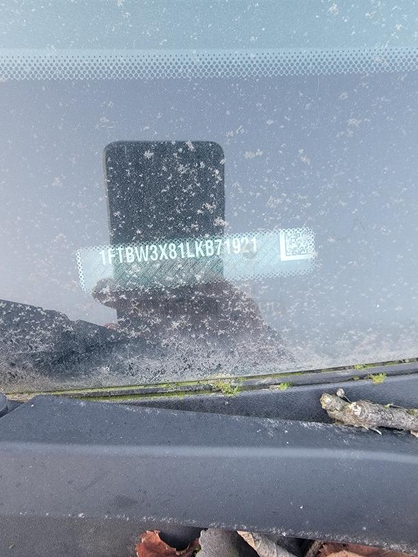 VIN visible through dusty windshield of 2021 Ford Transit 350 Cargo Van, reads 1FTBW3X81LKB71921.