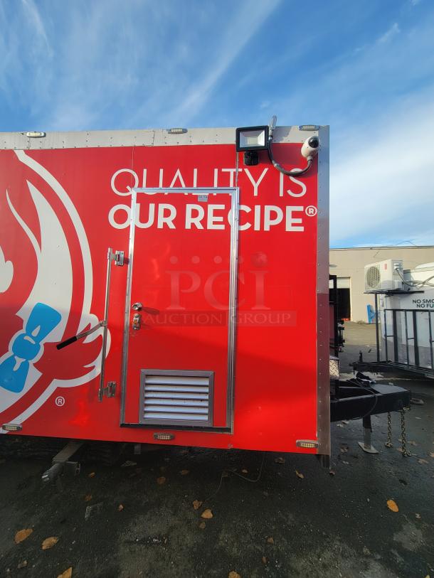 Virtually new 2021 Texino 28-foot food trailer, Wendy's branding, stainless steel interior, security camera, and lighting.