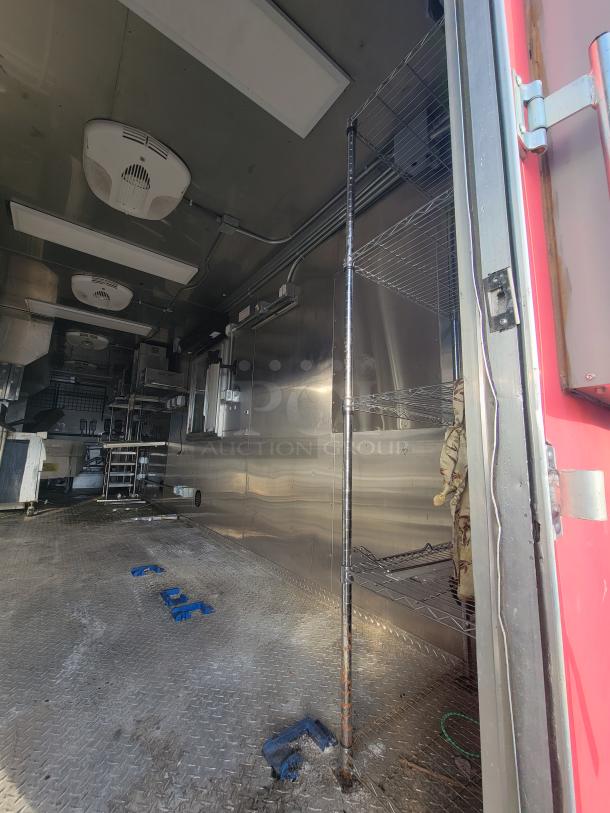 2021 Texino 28-foot food trailer interior, featuring stainless steel surfaces and shelving, ready for high-volume service.