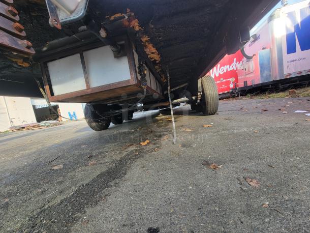 Underside view of a 2021 Texino 28-foot food trailer, showcasing its chassis and wheels.