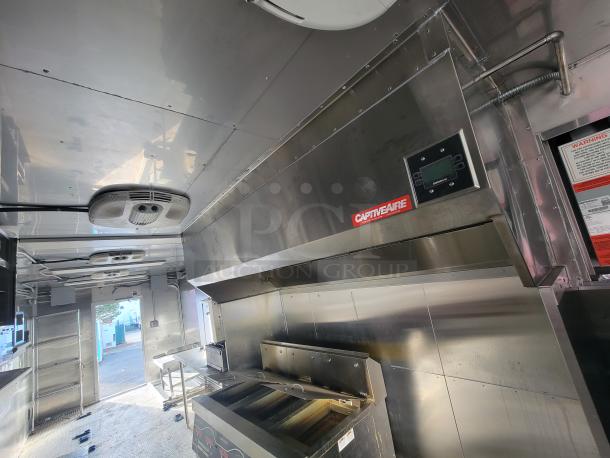 2021 Texino 28-ft food trailer with stainless steel interior, CaptiveAire exhaust hood, and premium commercial equipment.