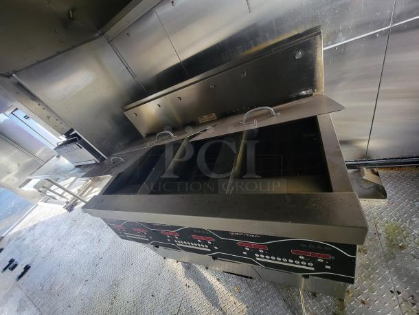 2021 Texino 28-foot food trailer interior with Henny Penny Heated Holding Cabinet, showcasing stainless steel surfaces and equipment.
