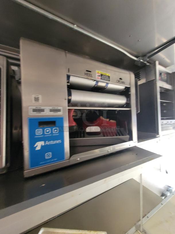 Antunes Vertical Contact Toaster inside 2021 Texino 28-foot food trailer, stainless steel, for high-volume operations.