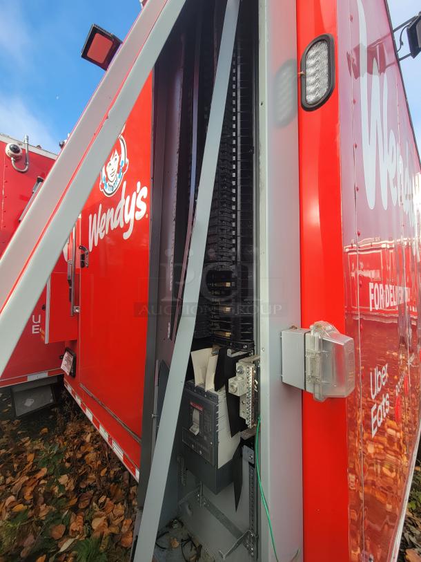 2022 Rock Solid 28' food trailer, unused, high-end equipment, pristine condition. Exterior with vivid red graphics.