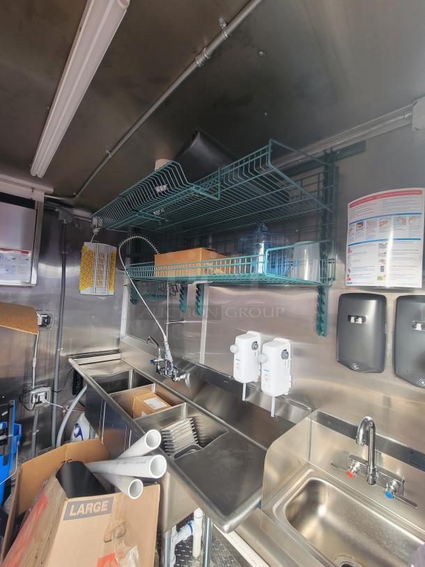 2022 Rock Solid 28' food trailer, never used, pristine stainless steel interior, high-end equipment, storage racks.