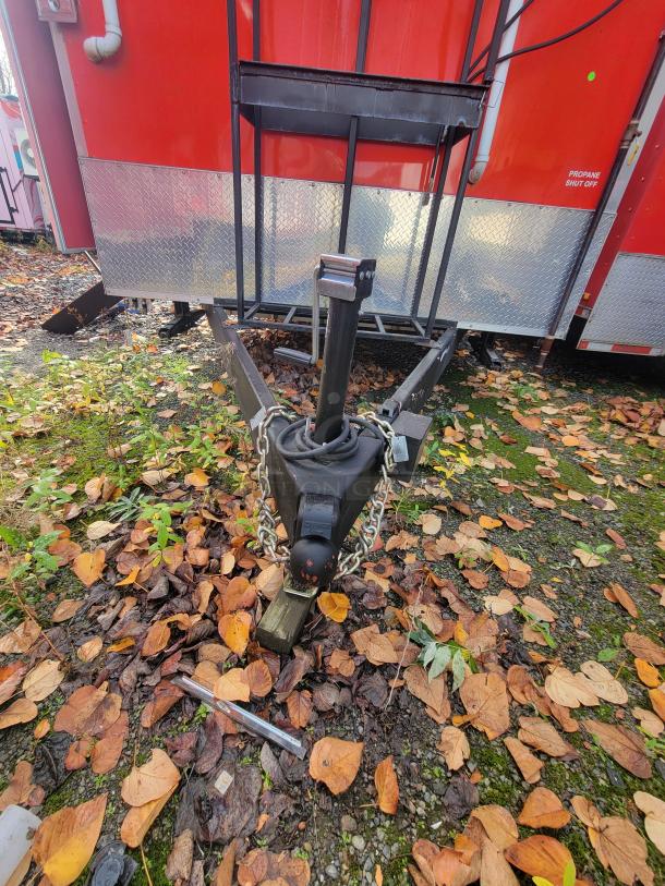 2022 Rock Solid 28' food trailer hitch, pristine condition, red exterior, "Propane Shut Off" label visible.