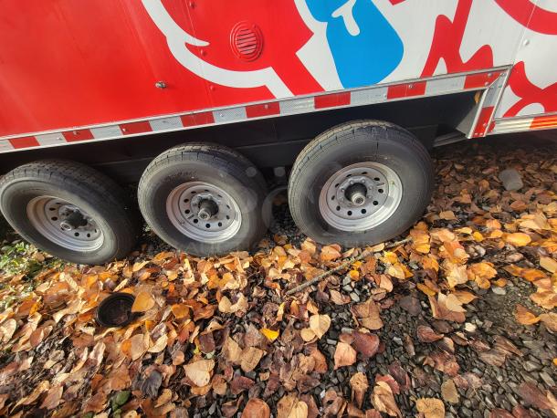 2022 Rock Solid 28' Food Trailer, triple axle, red with graphics, pristine condition, unused high-end equipment.