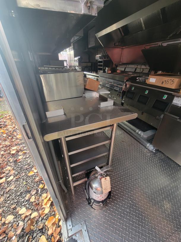 2022 Rock Solid 28' food trailer interior with stainless steel commercial kitchen equipment; never used, pristine condition.