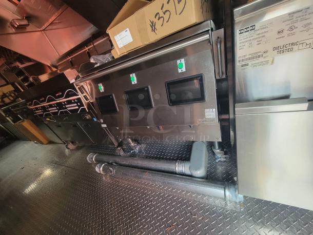 2022 Rock Solid 28' food trailer interior with stainless steel, high-end commercial kitchen equipment, never used, pristine.