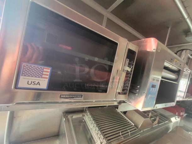 2022 Rock Solid 28' food trailer interior with premium Menumaster commercial equipment, pristine condition, "Fabricated in USA" label.