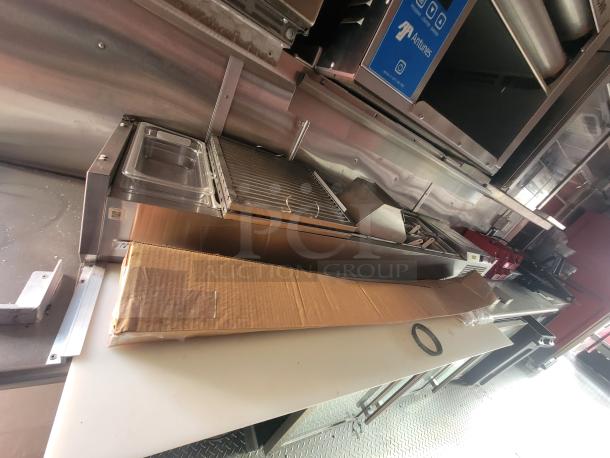 2022 Rock Solid 28' food trailer interior with new high-end commercial kitchen equipment and stainless steel finish.