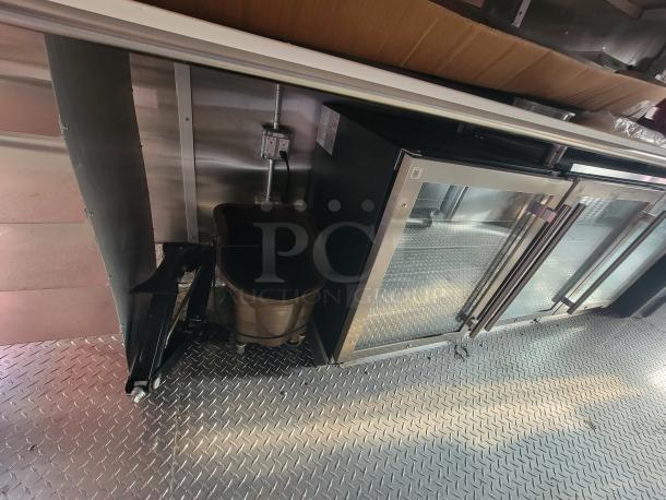 2022 Rock Solid 28' food trailer interior, featuring brand new commercial kitchen equipment, stainless surfaces, and diamond plate flooring.