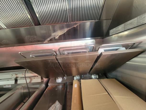 2022 Rock Solid 28' food trailer interior, featuring unused, high-end commercial kitchen equipment and stainless steel surfaces.