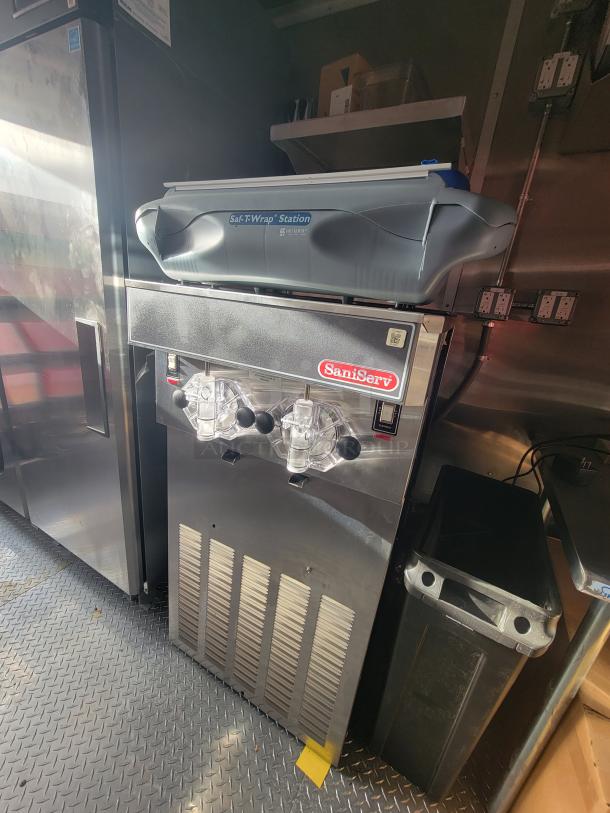 2022 Rock Solid 28' food trailer, never used; features SaniServ ice cream machine and Saf-T-Wrap station, pristine condition.