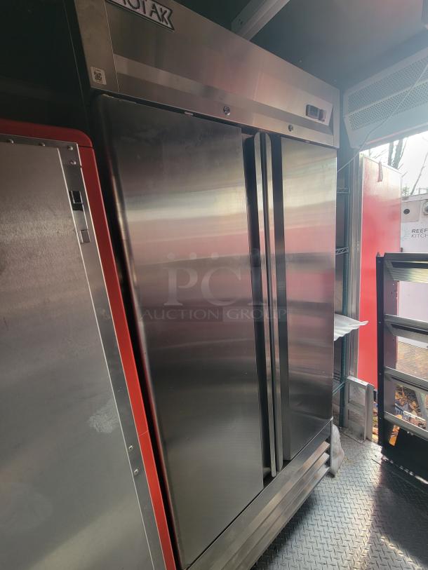 2022 Rock Solid 28' food trailer interior with unused high-end commercial equipment and stainless steel appliances.