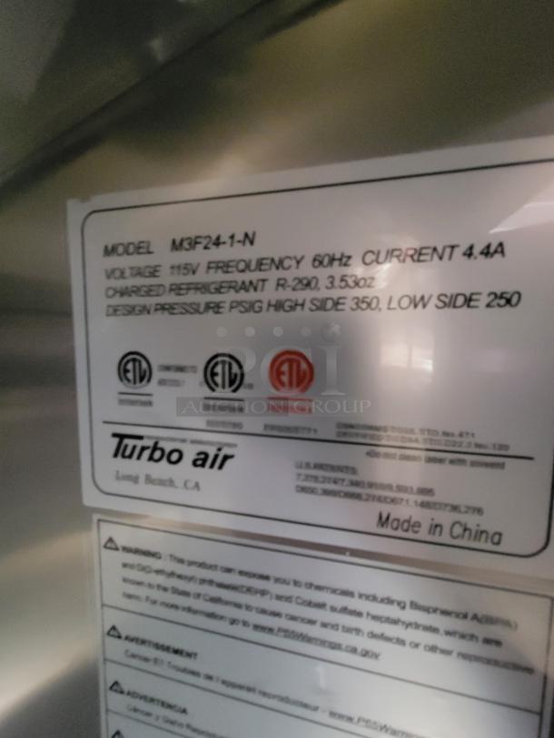 Label on 2022 Rock Solid 28' Food Trailer, featuring Turbo Air specs: Model M3F24-1-N, voltage 115V, current 4.4A, high-end commercial equipment.